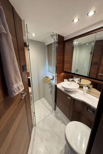  Yacht Photos Pics Luxurious bathroom in 2020 Princess F55 yacht with modern fixtures and elegant wood finishes.