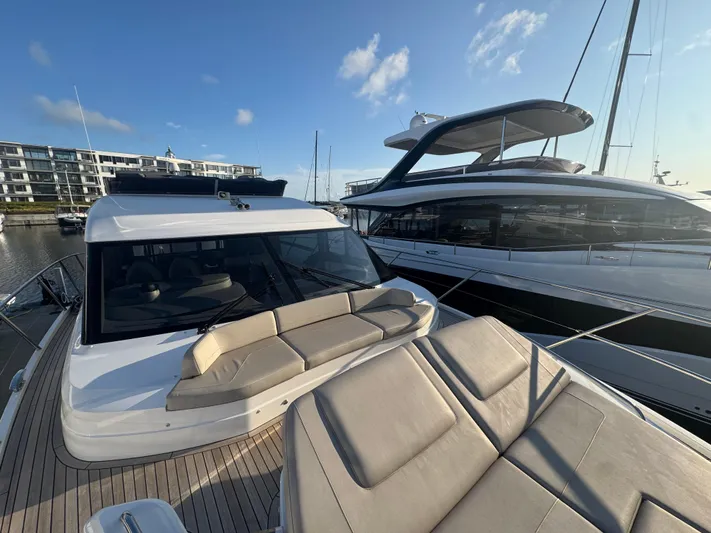  Yacht Photos Pics 2020 Princess F55 yacht with sleek design, docked in a marina under a clear blue sky.