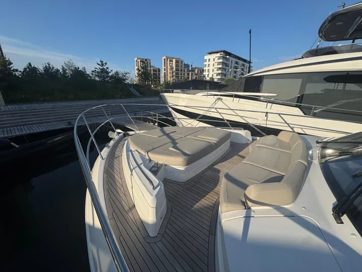 Yacht Photos Pics Luxury Princess F55 yacht deck with seating, docked near modern buildings, 2020 model.