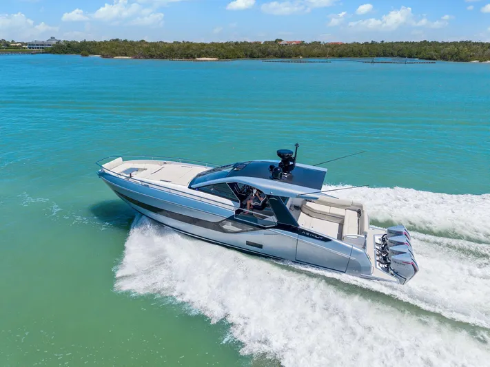Why Knot Yacht Photos Pics 2022 Azimut 47 VERVE yacht cruising on turquoise waters under a clear blue sky.