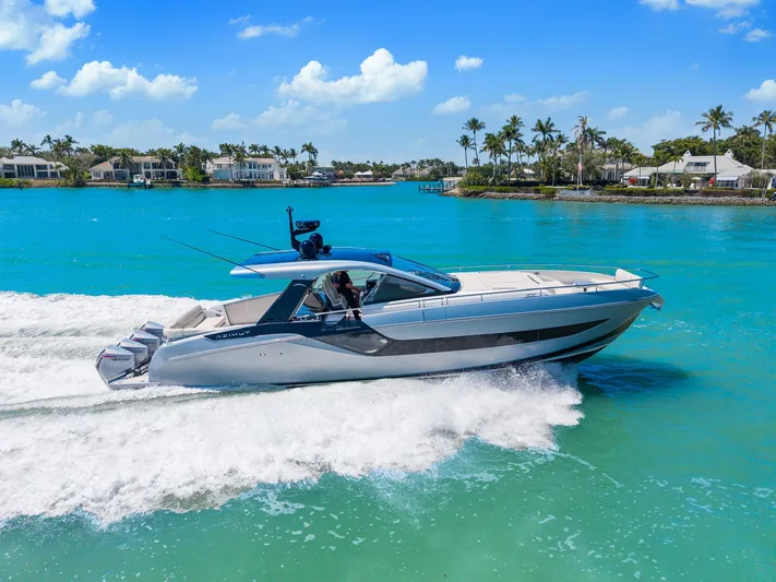 Why Knot Yacht Photos Pics Azimut 47 VERVE 2022 cruising on turquoise waters near a tropical shoreline.