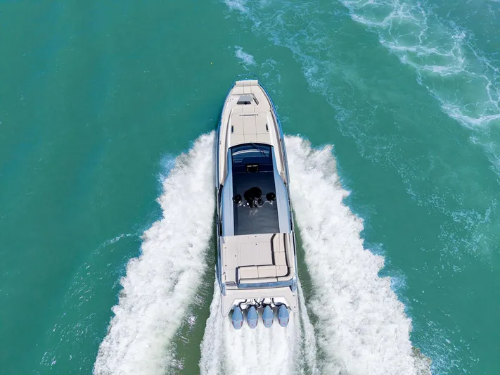Why Knot Yacht Photos Pics Azimut 47 VERVE 2022 luxury yacht cruising on turquoise water, aerial view.