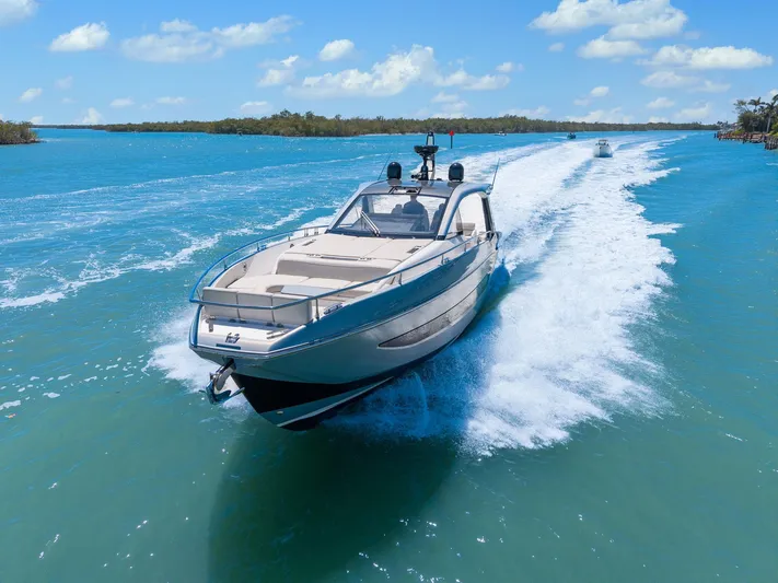 Why Knot Yacht Photos Pics 2022 Azimut 47 VERVE yacht cruising on clear blue water under a sunny sky.
