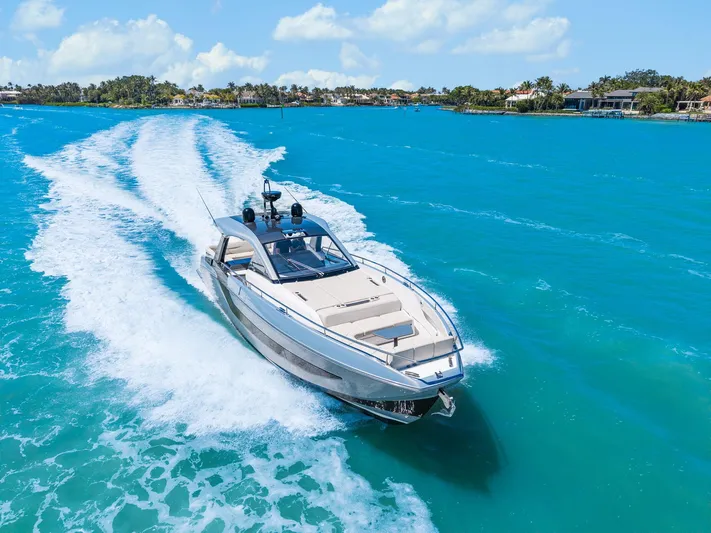 Why Knot Yacht Photos Pics Azimut 47 VERVE 2022 yacht cruising on turquoise waters under a clear sky.