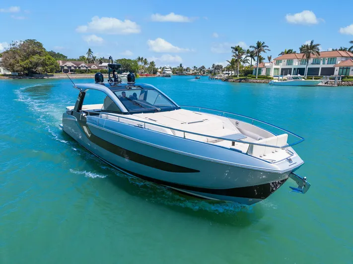 Why Knot Yacht Photos Pics 2022 Azimut 47 VERVE yacht cruising in a tropical waterfront setting.