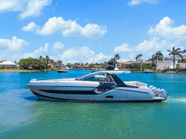 Why Knot Yacht Photos Pics 2022 Azimut 47 VERVE yacht cruising on a sunny day in a scenic coastal area.