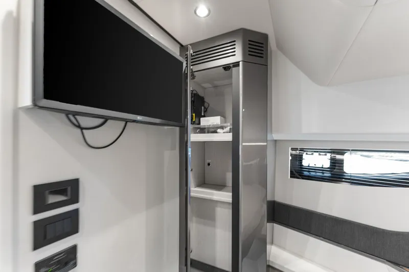 Why Knot Yacht Photos Pics Interior of 2022 Azimut 47 VERVE yacht with TV and storage cabinet.