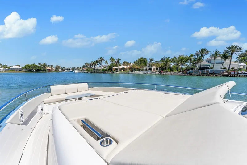 Why Knot Yacht Photos Pics Azimut 47 VERVE 2022 yacht on serene water with clear blue sky.