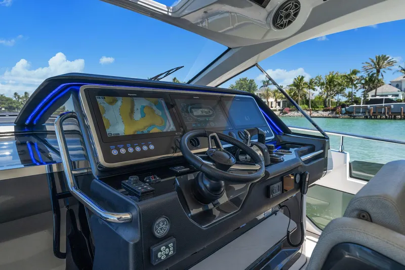 Why Knot Yacht Photos Pics Cockpit of 2022 Azimut 47 VERVE yacht with modern navigation system and scenic water view.