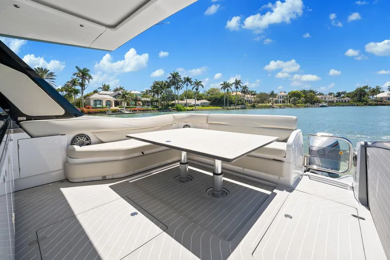 Why Knot Yacht Photos Pics Azimut 47 VERVE 2022 yacht deck with seating, table, and scenic waterfront view.