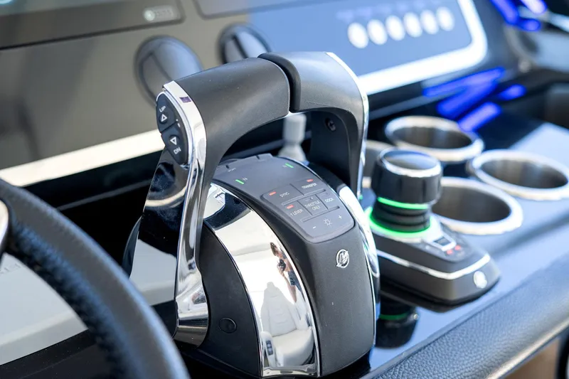 Why Knot Yacht Photos Pics Control panel of 2022 Azimut 47 VERVE yacht, featuring modern throttle and joystick.