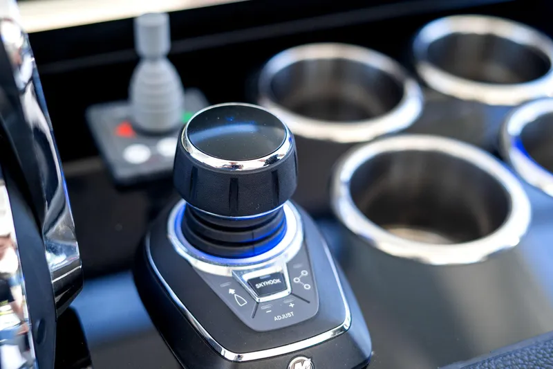 Why Knot Yacht Photos Pics Control panel of 2022 Azimut 47 VERVE yacht with joystick and cup holders.
