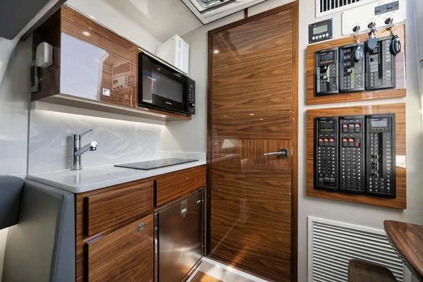  Yacht Photos Pics 2023 Valhalla Boatworks V-46 interior with modern kitchen and control panels.