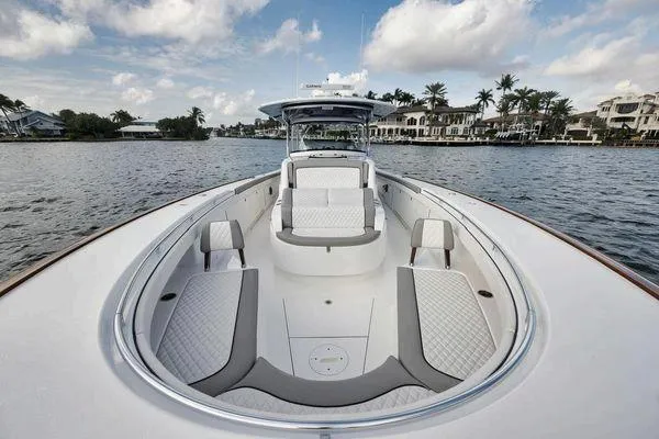  Yacht Photos Pics 2023 Valhalla Boatworks V-46 on water, luxurious seating, scenic waterfront view.