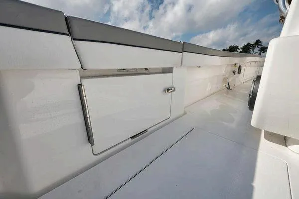  Yacht Photos Pics 2023 Valhalla Boatworks V-46 deck with storage compartment, under a partly cloudy sky.