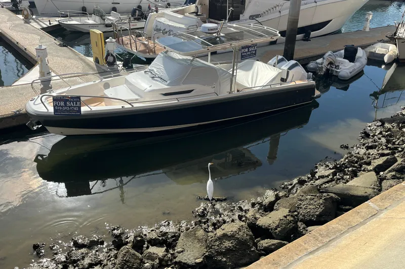 San #155 In Stock Yacht Photos Pics 2024 Nimbus T9 boat for sale at marina, with heron nearby.