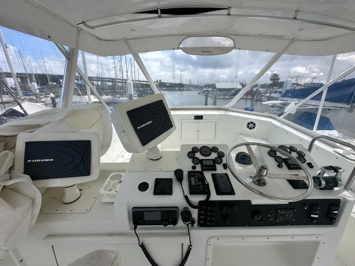 The Godfather Yacht Photos Pics 1986 Hatteras 52 Convertible yacht helm with navigation equipment and marina view.