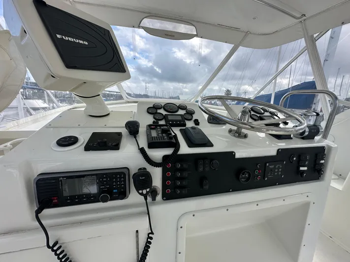 The Godfather Yacht Photos Pics 1986 Hatteras 52 Convertible helm with navigation equipment and steering wheel.