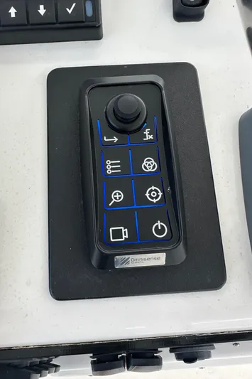 The Godfather Yacht Photos Pics Control panel of a 1986 Hatteras 52 Convertible boat with joystick and buttons.