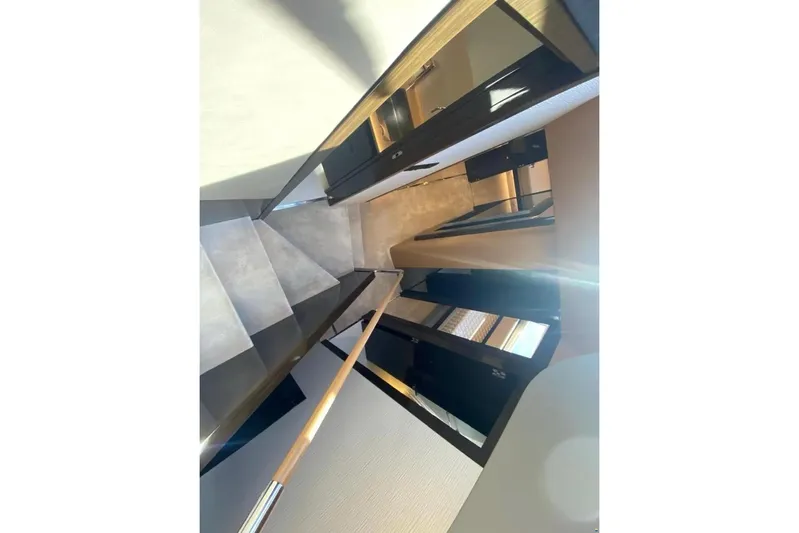 Titta Yacht Photos Pics Interior staircase of 2016 Azimut 77S yacht, featuring sleek modern design and wood accents.