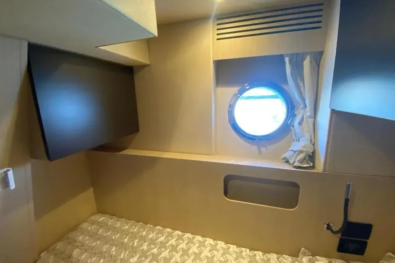 Titta Yacht Photos Pics Cabin interior of 2016 Azimut 77S yacht with porthole and modern design.