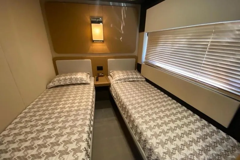 Titta Yacht Photos Pics Twin beds in a 2016 Azimut 77S yacht cabin with modern decor.