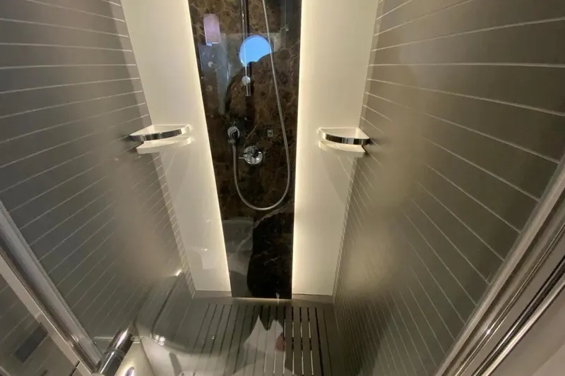 Titta Yacht Photos Pics Luxurious shower in 2016 Azimut 77S yacht with modern fixtures and sleek design.