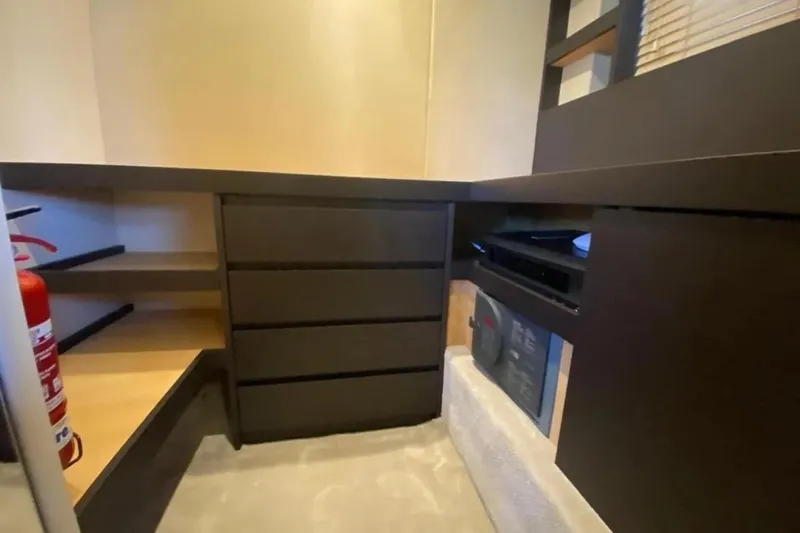 Titta Yacht Photos Pics Interior storage area of 2016 Azimut 77S yacht with shelves and drawers.