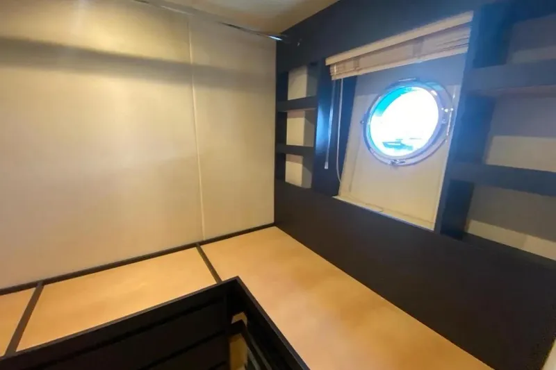 Titta Yacht Photos Pics Interior cabin of 2016 Azimut 77S yacht with porthole window and modern design.