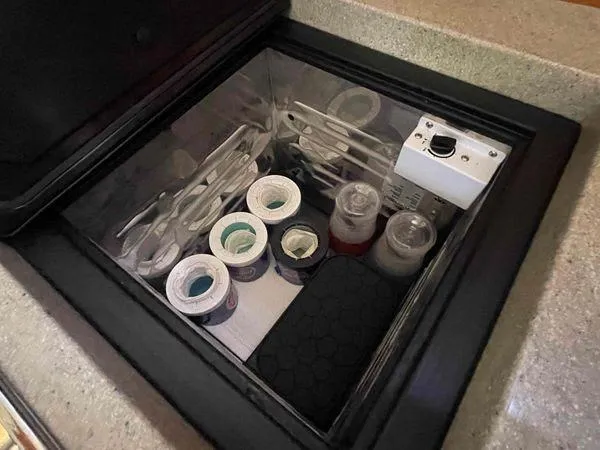 Top O Nok Yacht Photos Pics Storage compartment in a 2020 Tartan 395 yacht, containing various items and supplies.