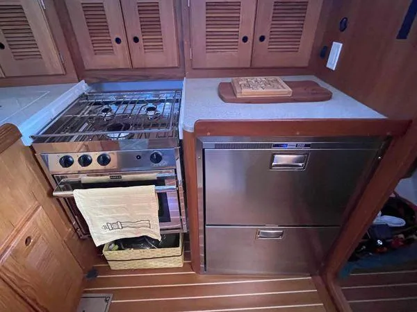Top O Nok Yacht Photos Pics Galley kitchen in 2020 Tartan 395 yacht with stove and stainless steel appliances.