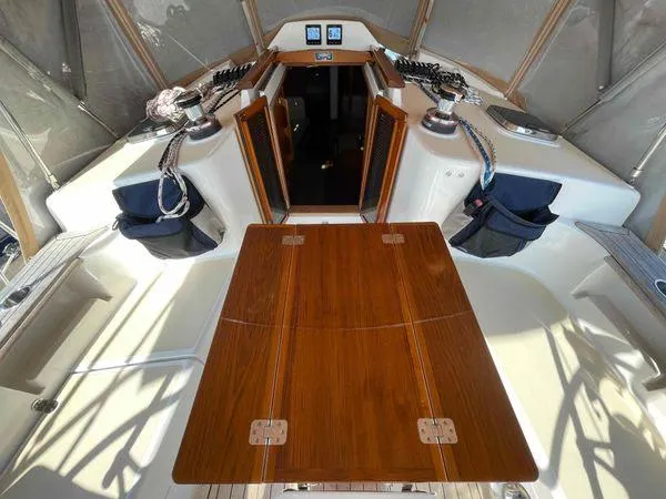 Top O Nok Yacht Photos Pics 2020 Tartan 395 yacht cockpit with wooden table and open cabin doors.
