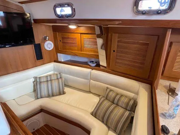 Top O Nok Yacht Photos Pics Luxurious interior of 2020 Tartan 395 yacht with cozy seating and elegant wood finishes.