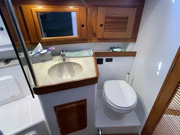 Top O Nok Yacht Photos Pics Bathroom interior of 2020 Tartan 395 yacht with wooden cabinetry and modern fixtures.
