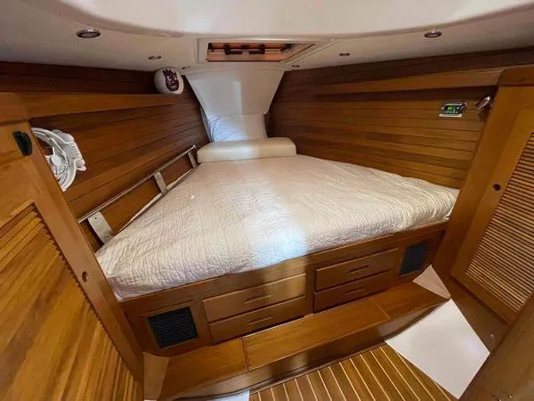 Top O Nok Yacht Photos Pics Luxurious cabin interior of 2020 Tartan 395 yacht with wooden finish and cozy bedding.