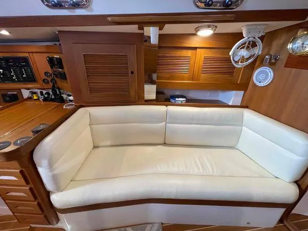 Top O Nok Yacht Photos Pics Luxurious interior of 2020 Tartan 395 yacht with cream sofa and wooden accents.