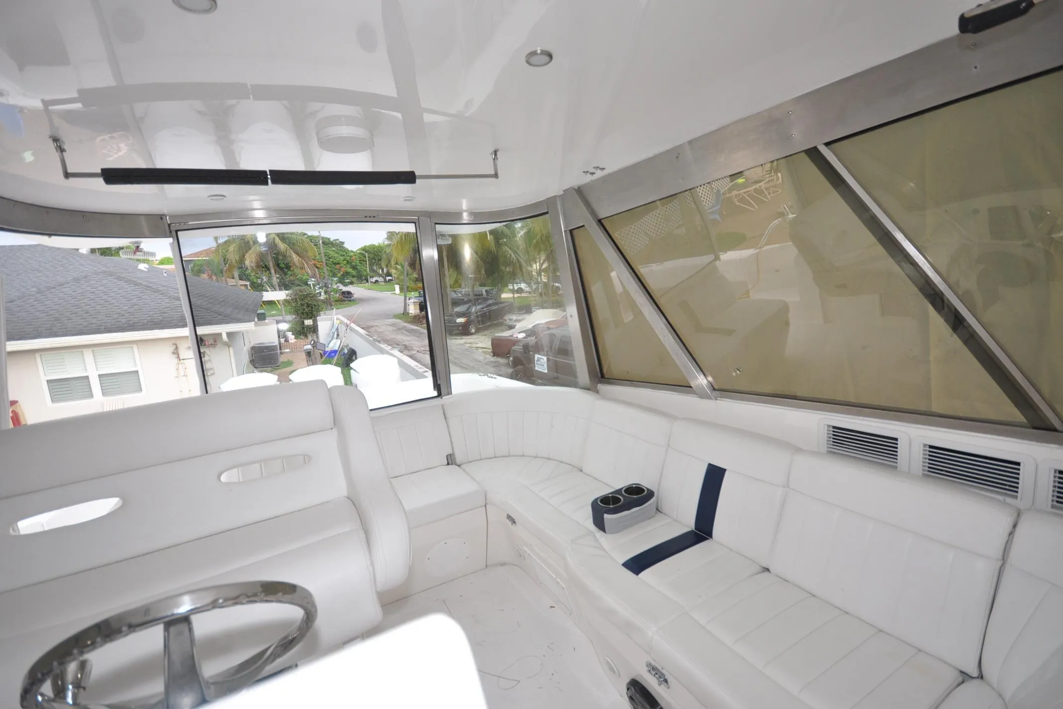 Interior of 2009 Intrepid 430 Sport Yacht with white seating and panoramic windows.