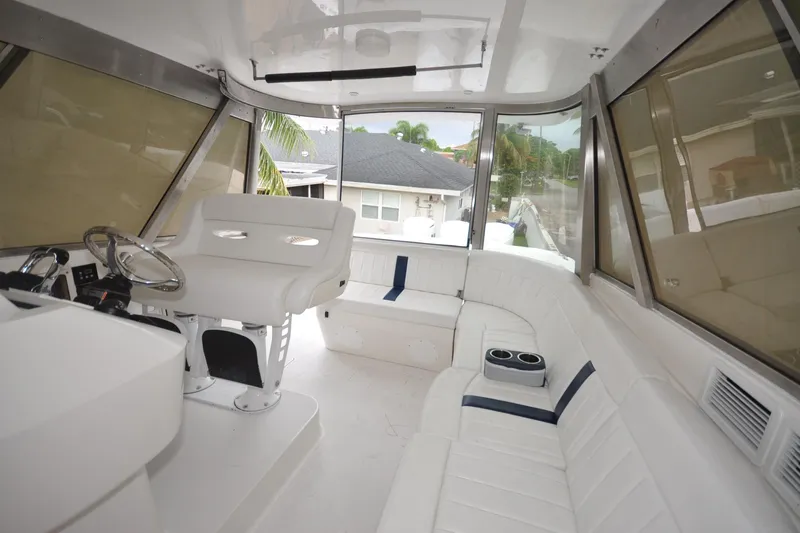  Yacht Photos Pics Luxurious interior of 2009 Intrepid 430 Sport Yacht with white seating and helm.