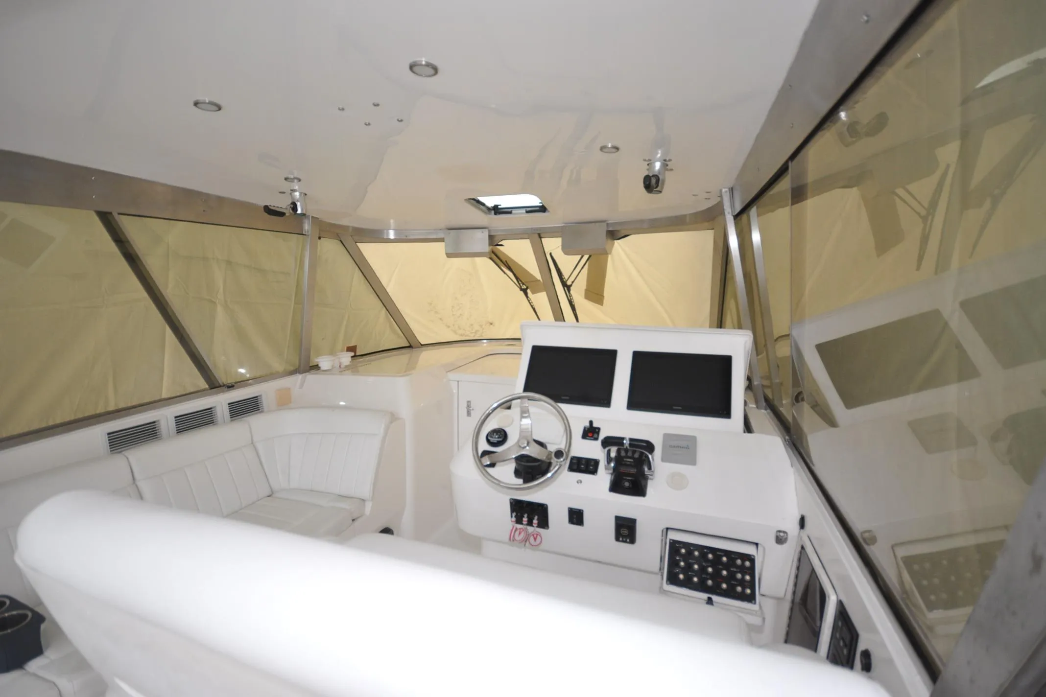 Interior view of 2009 Intrepid 430 Sport Yacht cockpit with steering wheel and control panels.
