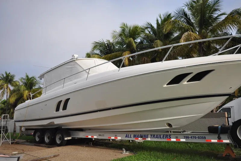  Yacht Photos Pics 2009 Intrepid 430 Sport Yacht on trailer, surrounded by palm trees.