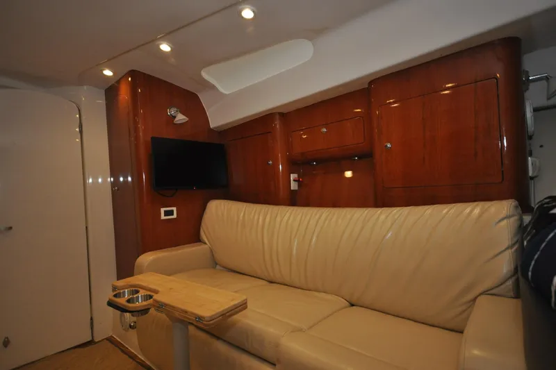  Yacht Photos Pics Interior of 2009 Intrepid 430 Sport Yacht with leather sofa and wooden cabinetry.