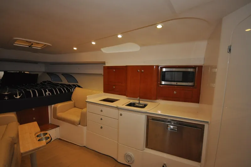  Yacht Photos Pics Interior of 2009 Intrepid 430 Sport Yacht with kitchenette and seating area.