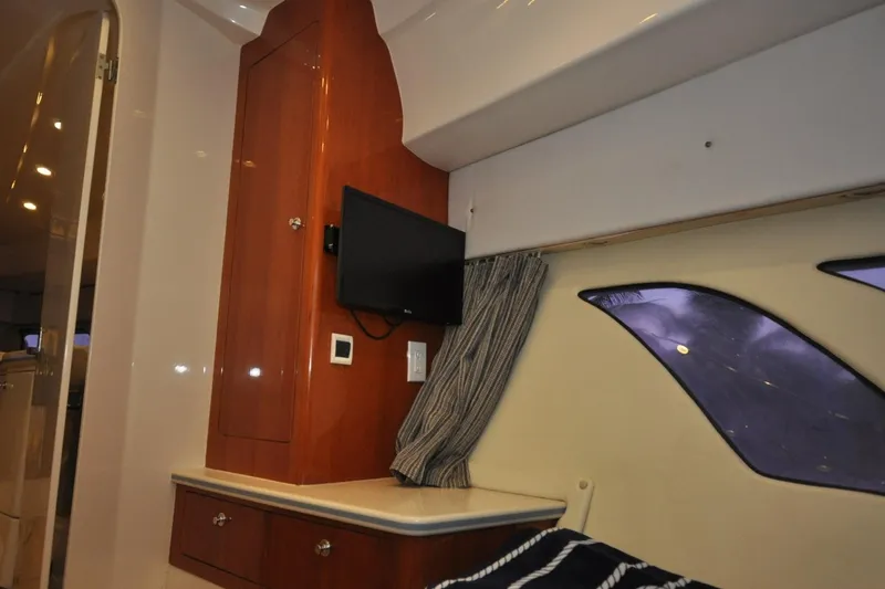  Yacht Photos Pics Interior of 2009 Intrepid 430 Sport Yacht with TV, wooden cabinetry, and window.