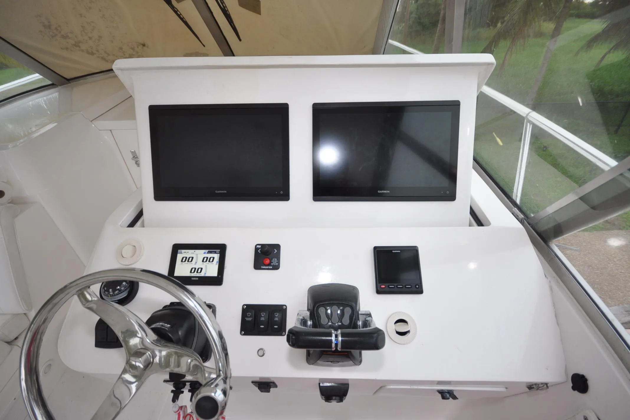 Helm of 2009 Intrepid 430 Sport Yacht with dual Garmin displays and steering wheel.