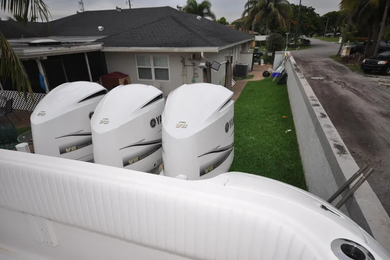 Yacht Photos Pics Triple Yamaha V8 engines on a 2009 Intrepid 430 Sport Yacht, parked beside a house.
