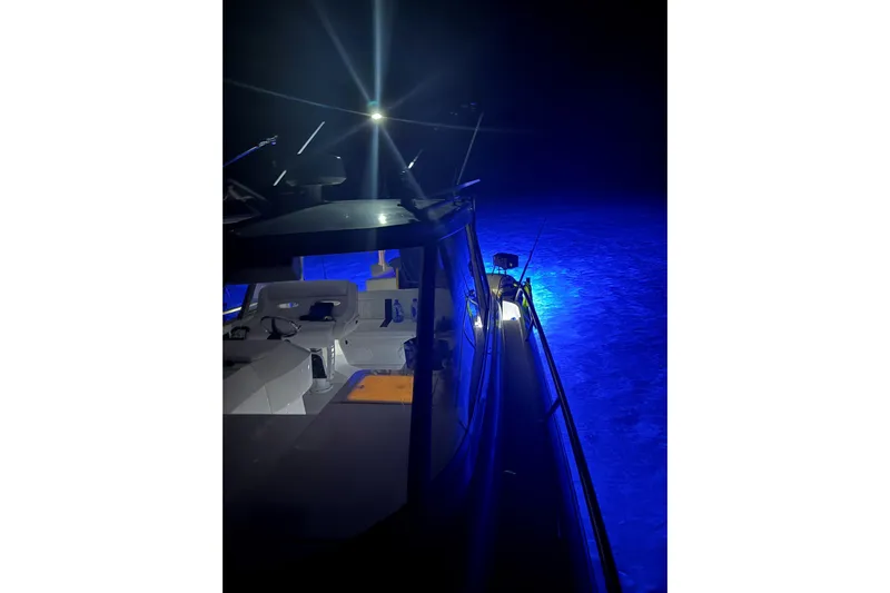  Yacht Photos Pics 2009 Intrepid 430 Sport Yacht illuminated at night with blue underwater lights.
