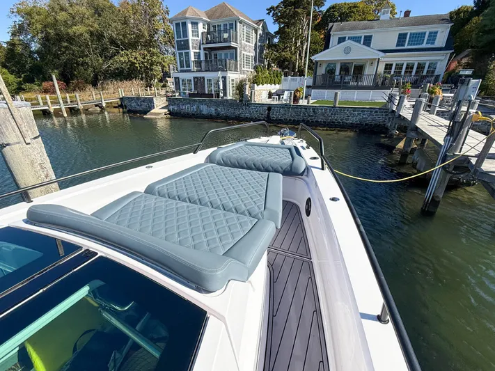  Yacht Photos Pics 2022 Axopar 37 Sun Top boat docked near waterfront homes.