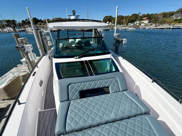  Yacht Photos Pics 2022 Axopar 37 Sun Top boat with luxurious seating, docked in a scenic marina.
