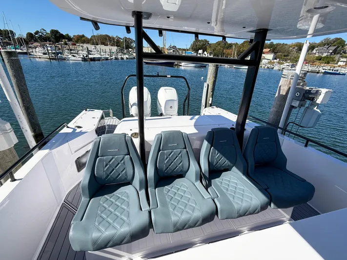  Yacht Photos Pics 2022 Axopar 37 Sun Top boat with stylish seating, docked at a marina.