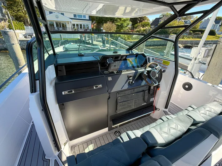  Yacht Photos Pics 2022 Axopar 37 Sun Top boat interior with modern helm and seating.